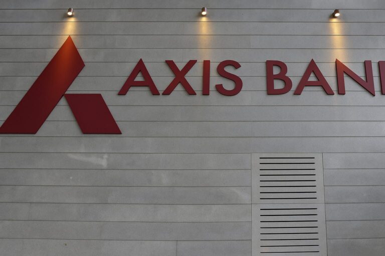 Axis Bank Q1 FY26 earnings report being analyzed by a financial expert on a digital tablet, with stock market charts and investor reaction in the background.